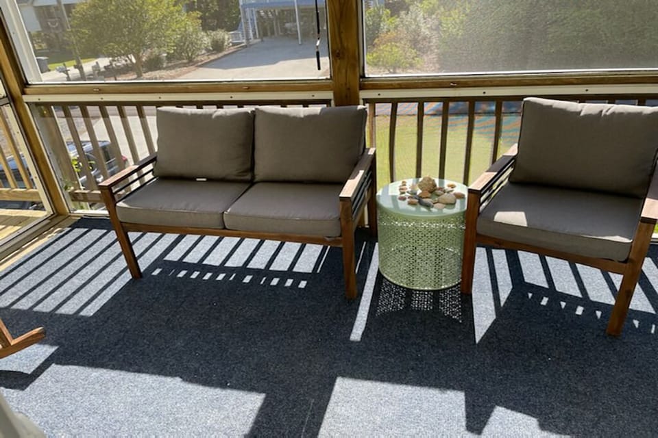 Screened-in porch with ample seating to enjoy a cup of coffee 