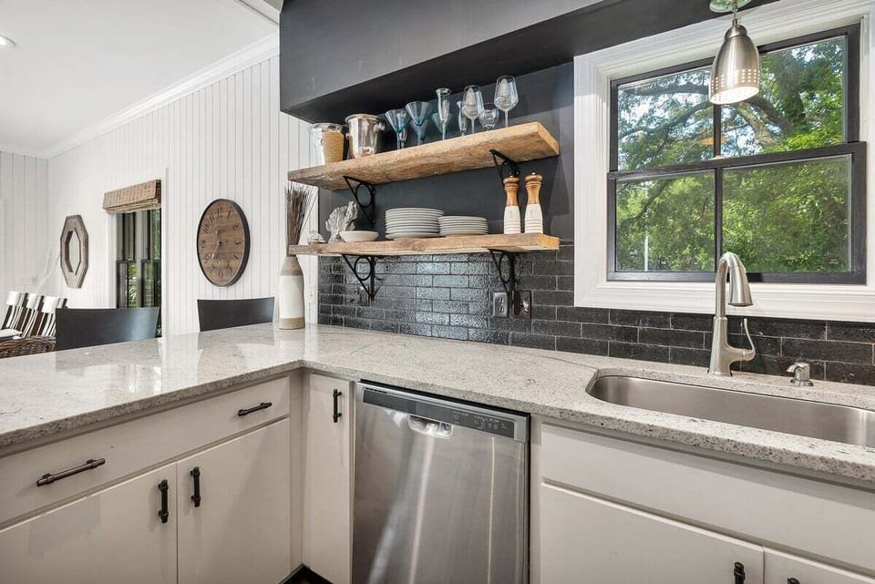 Close-up of kitchen with stainless steel appliances and shelving space