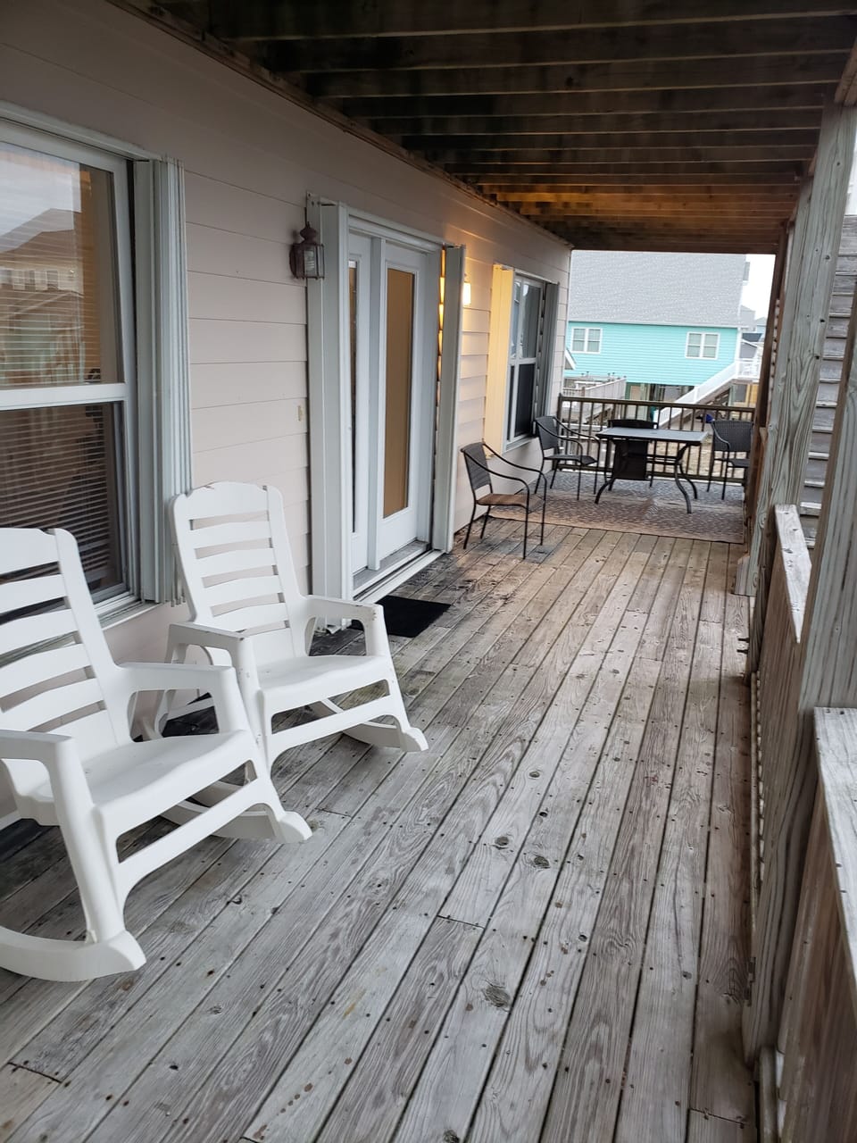 1st floor deck furnished with table and chairs and rockers