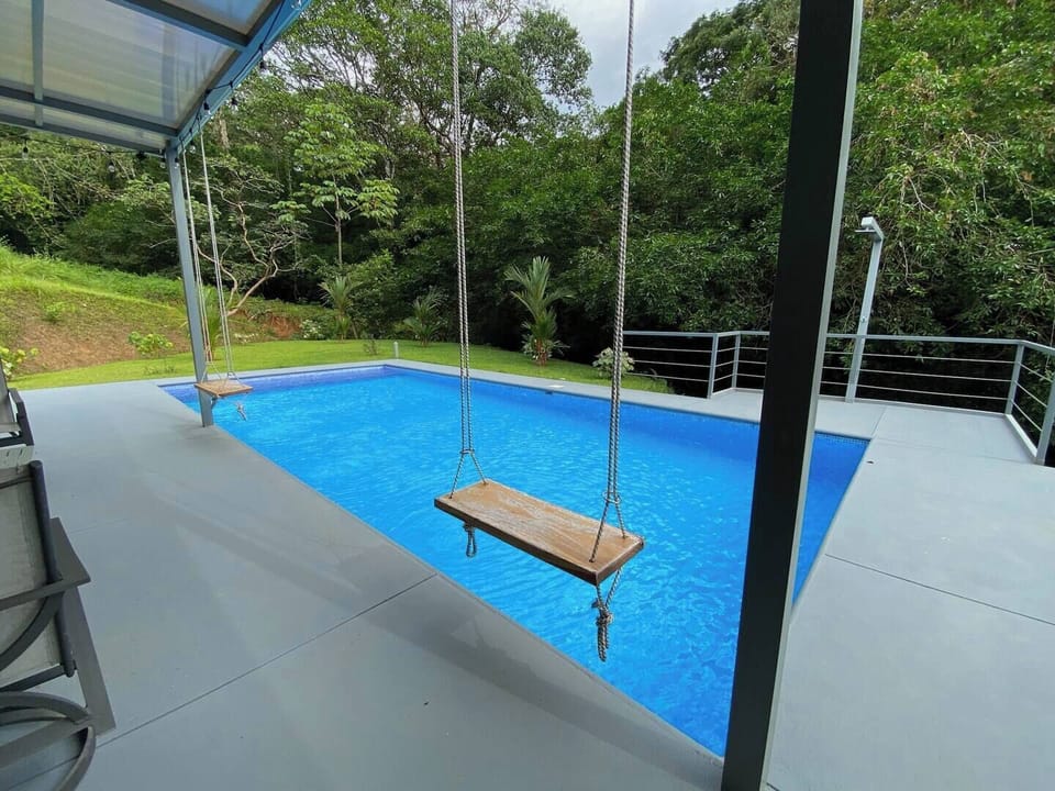  charming swing by the pool, perfect for lounging and enjoying the surroundings.
