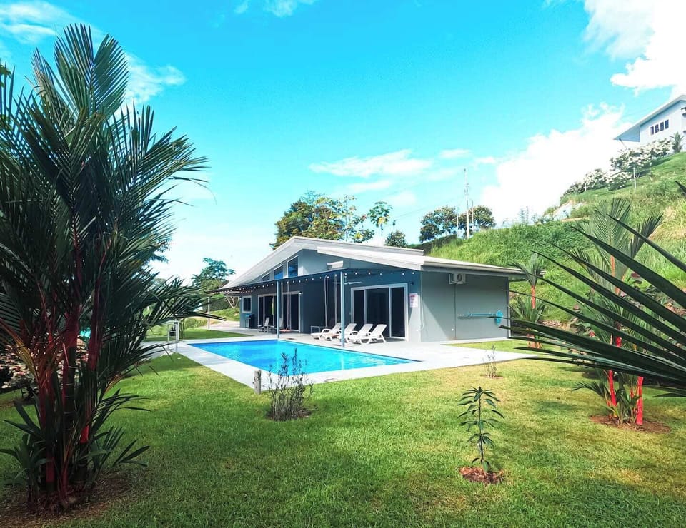 The house is surrounded by flourishing vegetation, adding beauty and privacy.