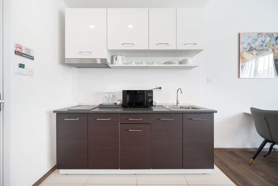2 Bedroom Junior | Private kitchen | Fridge, microwave, electric kettle, dining tables