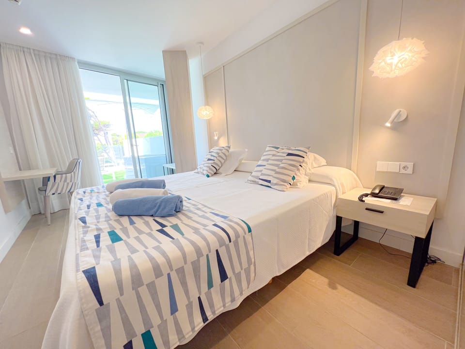 Junior Suite, Terrace, Pool View | Minibar, desk, laptop workspace, blackout drapes