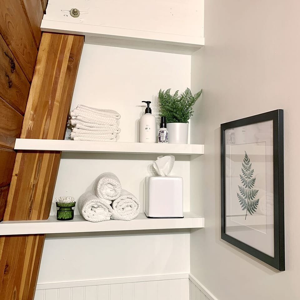 Bathroom shelving with extra supplies for your convenience.