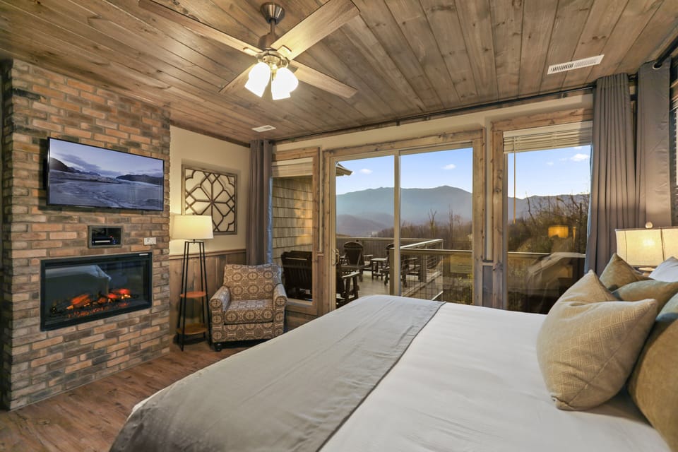 Bedroom #1 - Master Suite with fireplace, private bathroom, and deck access