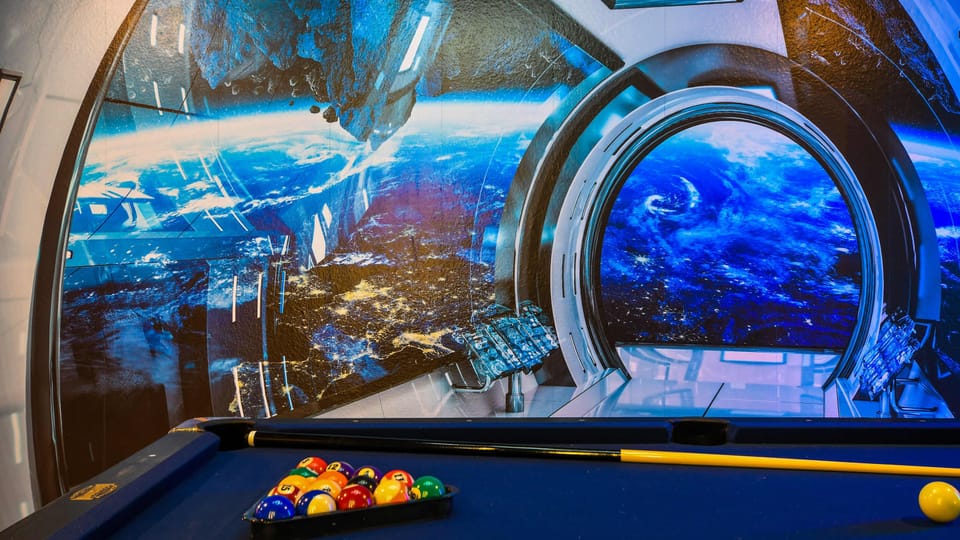 Space-themed game room with pool table and stunning galaxy wall mural atmosphere
