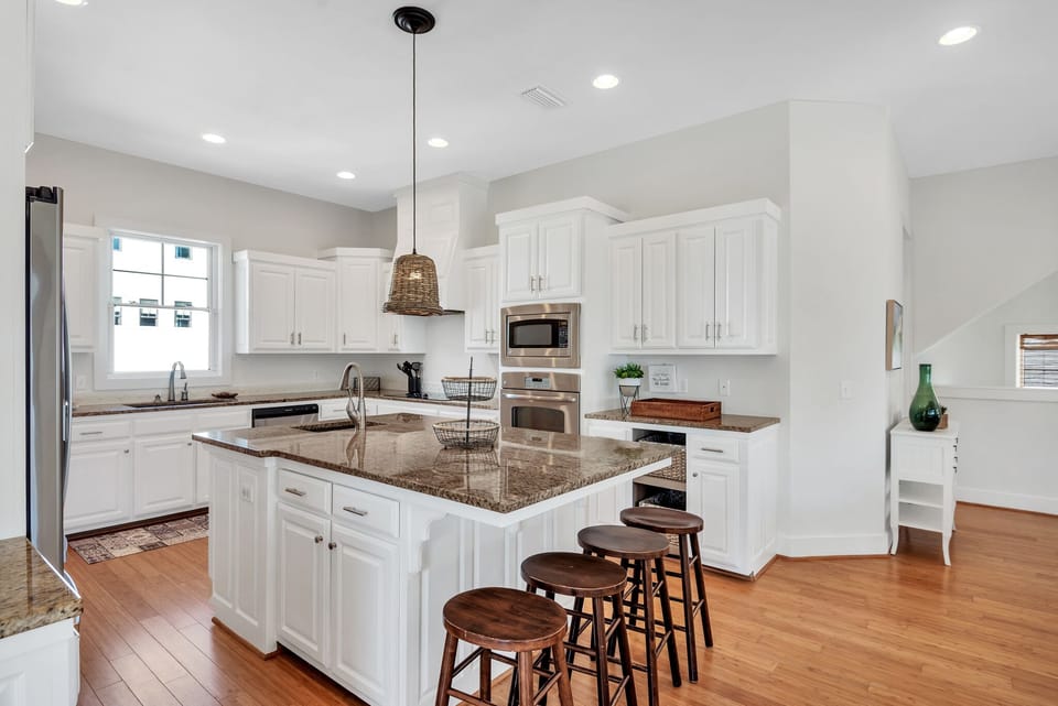 Oversized kitchen with gorgeous granite, spacious cabinets, stainless appliances, additional wet bar and island with extra seating (second level)