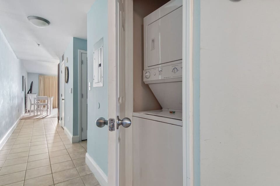 Hallway showing stackable washer/dryer closet