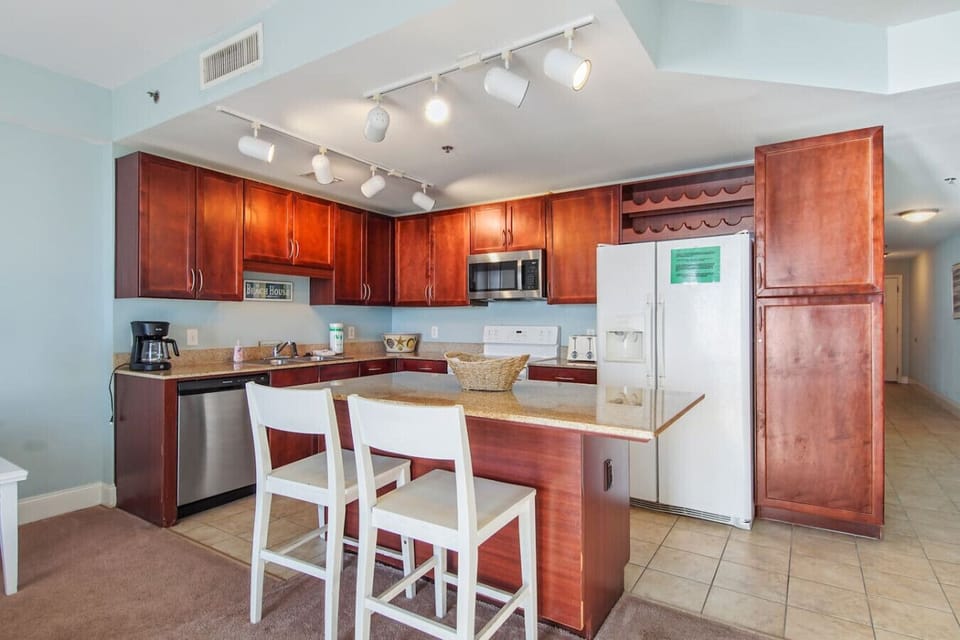 Fully stocked kitchen with island and seating for 2