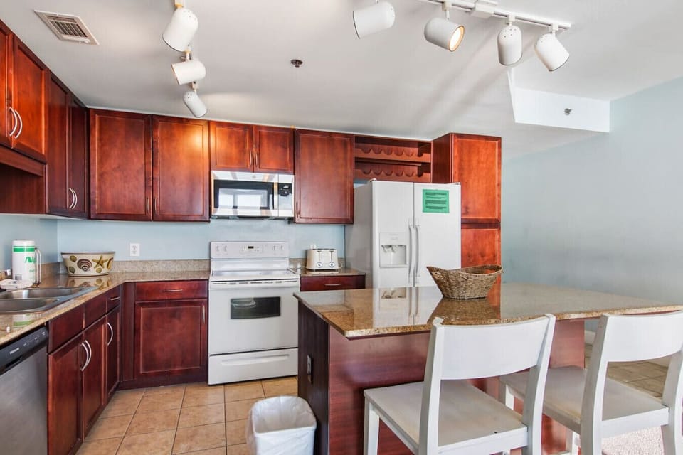 Fully stocked kitchen with island and seating for 2