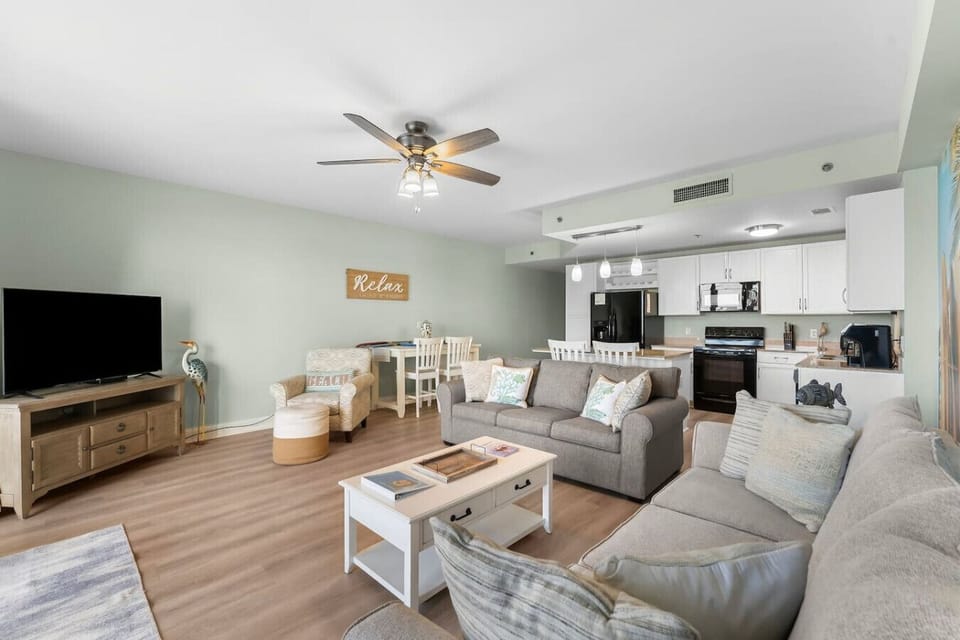 Living room with fold out couch and Flat screen TV/dine in area and view of Kitchen