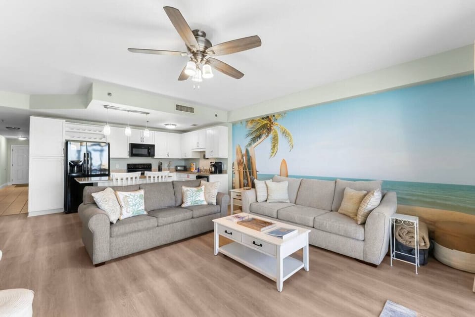 Living room with fold out couch and view of kitchen
