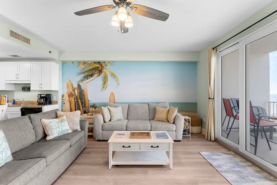 Living room with fold out couch/sliding glass doors with view of ocean