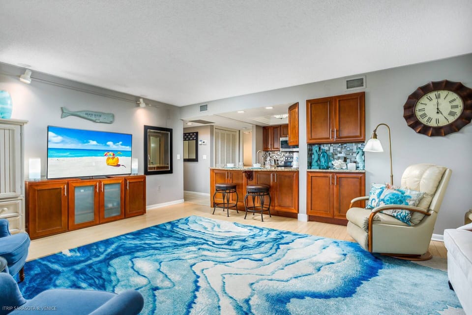 Large living room with plenty of seating and a Smart TV including cable.