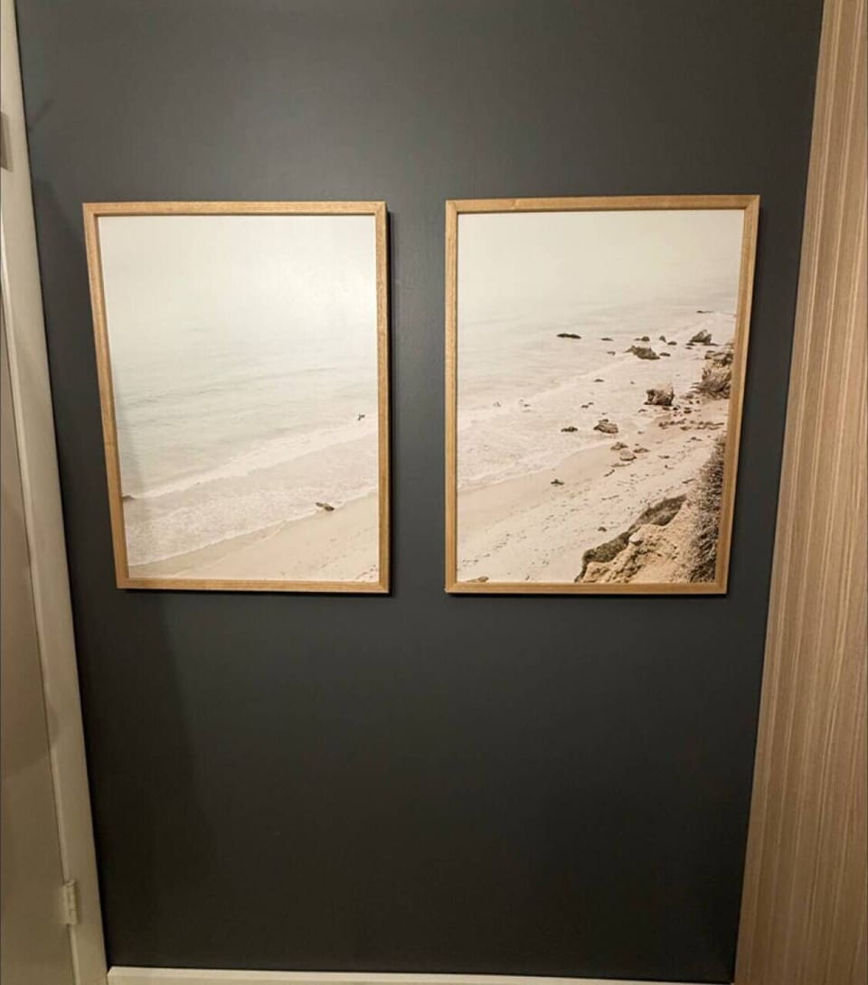 Coastal artwork adds a serene, beachy touch to this bathroom, bringing the calm of the shoreline indoors.