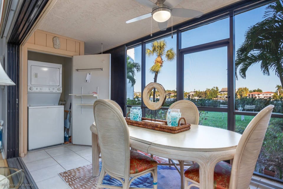 Screened lanai hosts the stacked washer & dryer.  Sit outside while your laundry gets cleaned