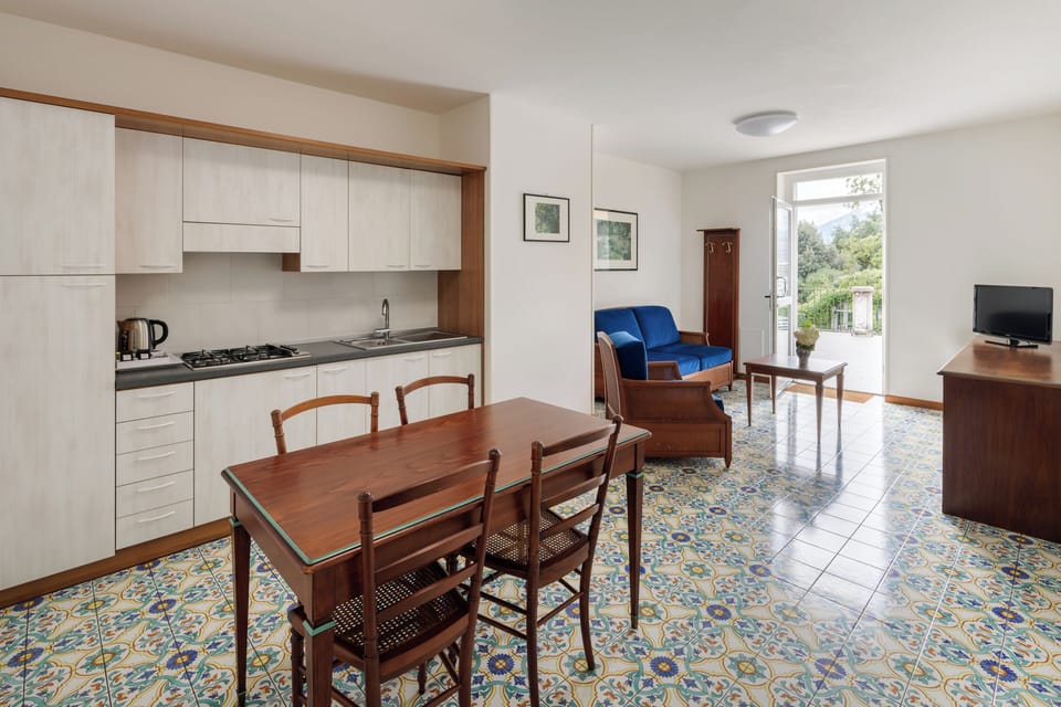 Standard Apartment, Kitchenette | Living area | 25-inch TV with satellite channels