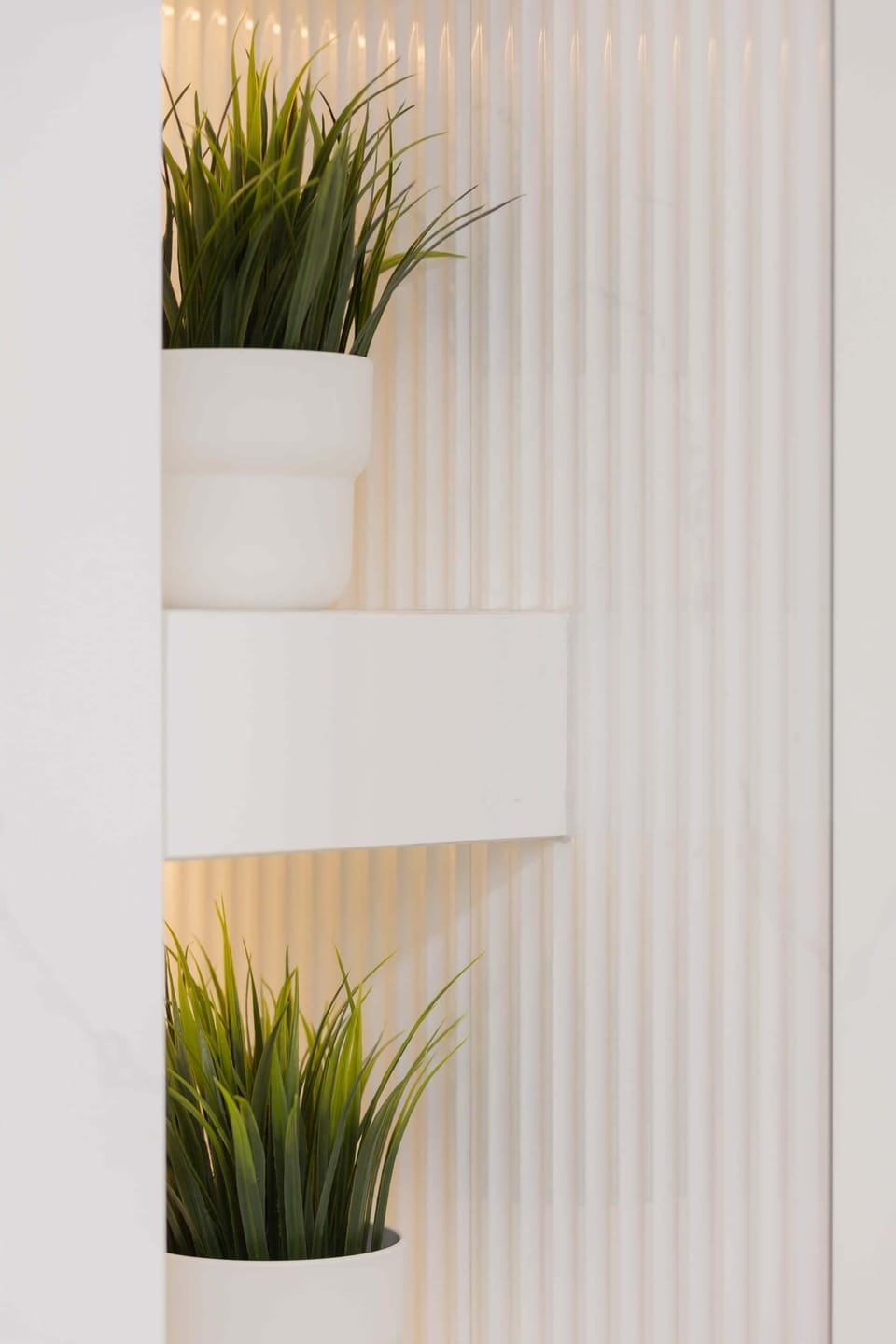A decorative shelf with plants and wooden accents, enhancing the apartment's charm.

