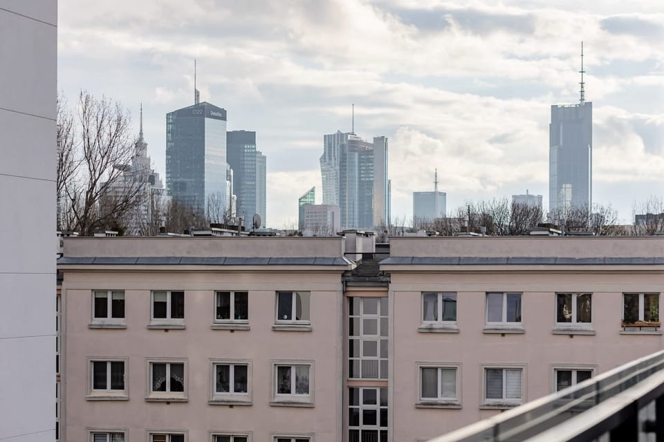 A panoramic cityscape view from the apartment, capturing the urban skyline.

