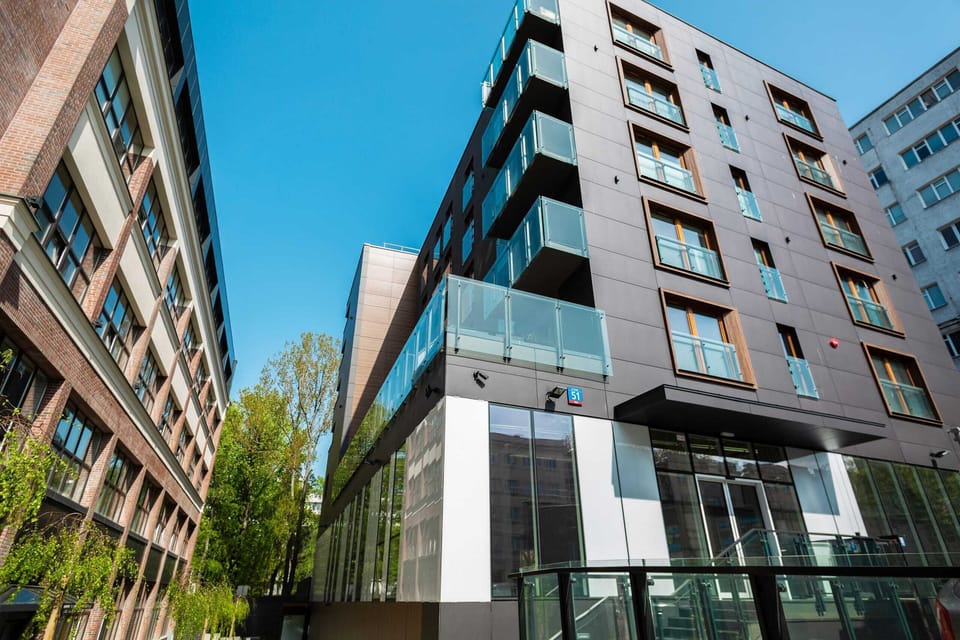 A view of the modern apartment building, showcasing its sleek architectural design.

