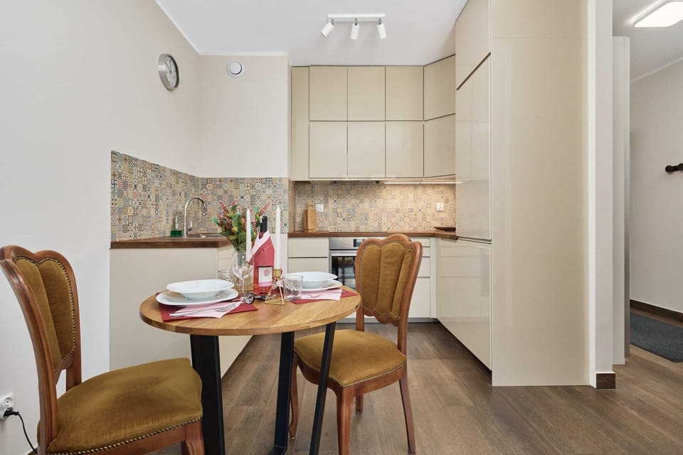 Intimate dining area with wooden furniture and bright lighting, perfect for meals.

