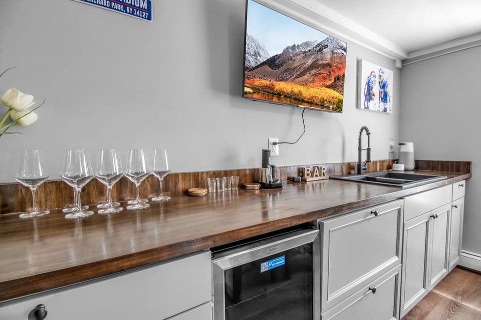 Compact and efficient kitchenette showcasing a modern design, complete with a sleek sink for practical functionality in a stylish space.