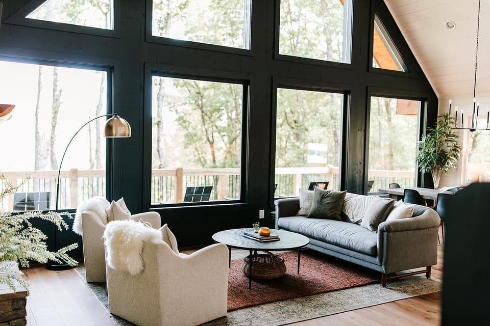 The main-level living room boasts massive floor-to-ceiling windows, which allow you to take in the incredible mountain views from the comfort of the sofa or plush chairs.