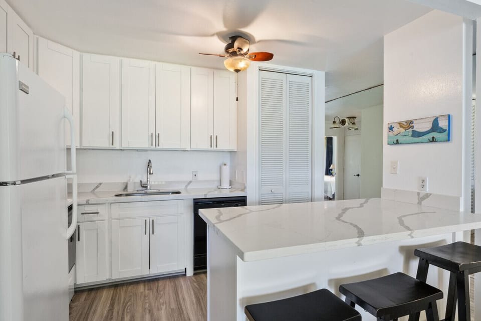 Clean white kitchen ready for easy vacation cooking.