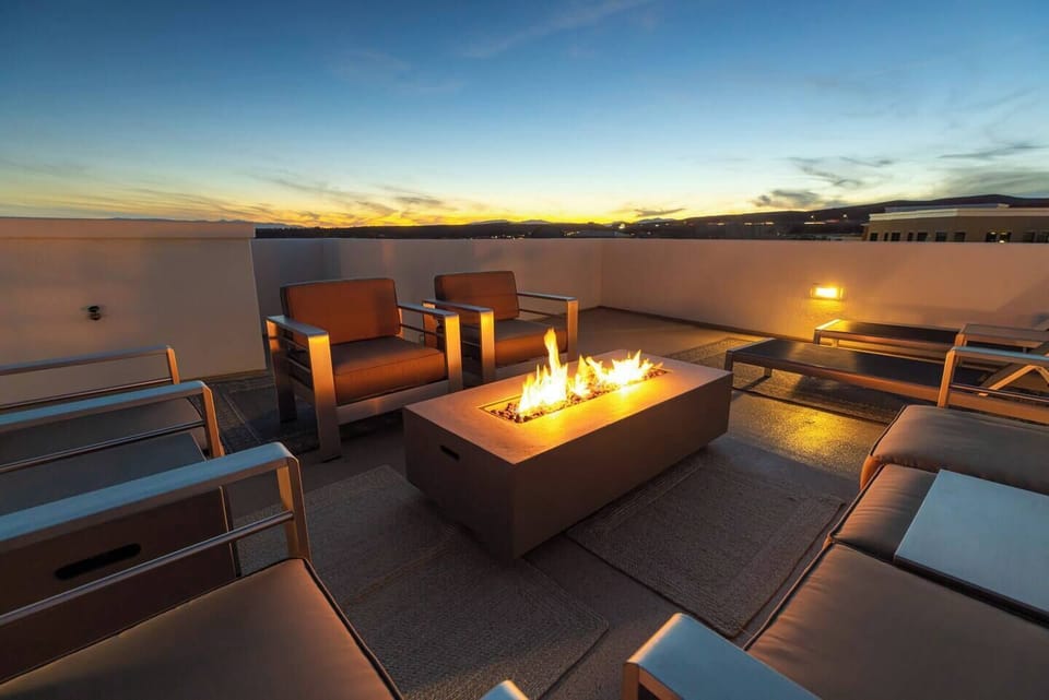 Enjoy evening sunsets around the fire on the rooftop lounge