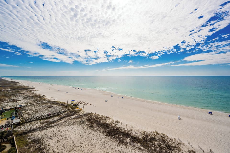 Take in the expansive views of the tranquil waters and soft shoreline from your inviting balcony space