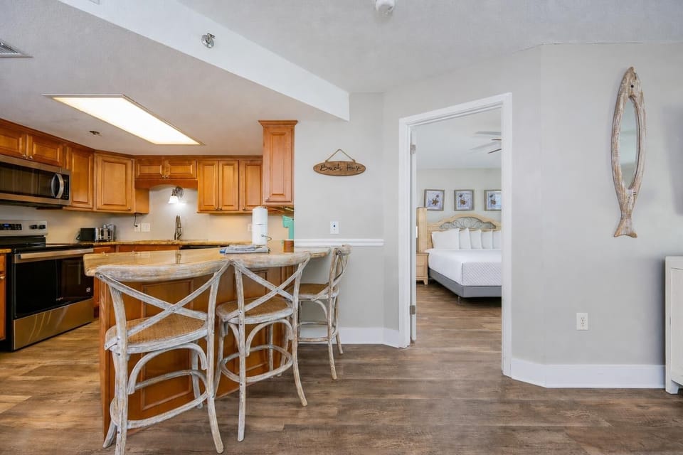 Rustic bar stools welcome you to savor morning coffee or chat beside the bright kitchen