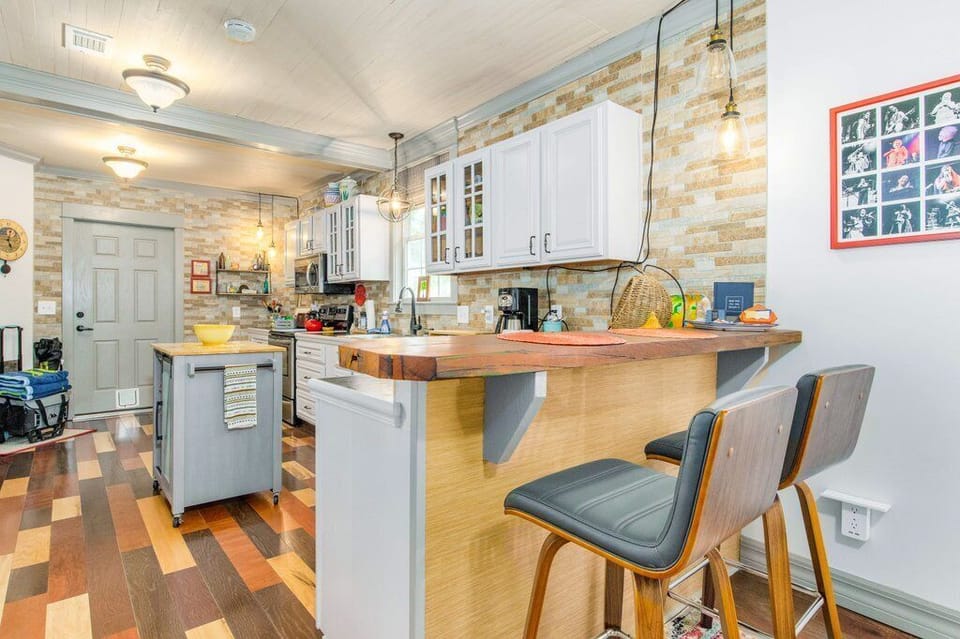 Modern kitchen island with bar seating and rustic wood countertops perfect for entertaining couples
