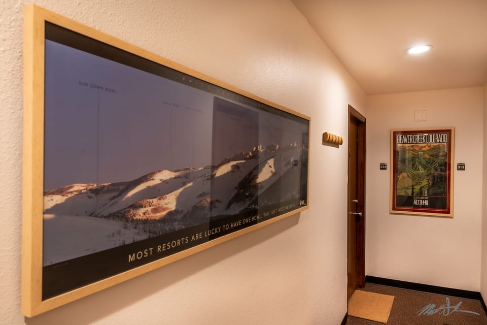 Exterior hallway has large bench for changing shoes and unloading bags and gear.