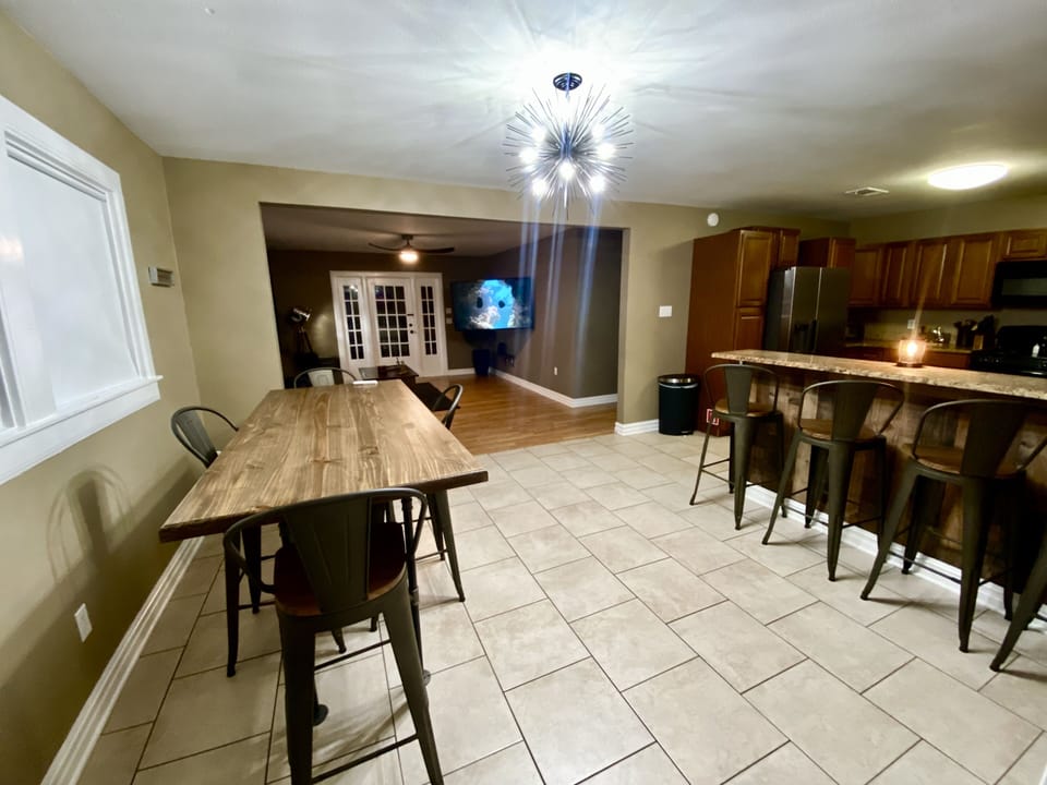 TV turns so everyone can gather around the table and bar and still watch a movie
