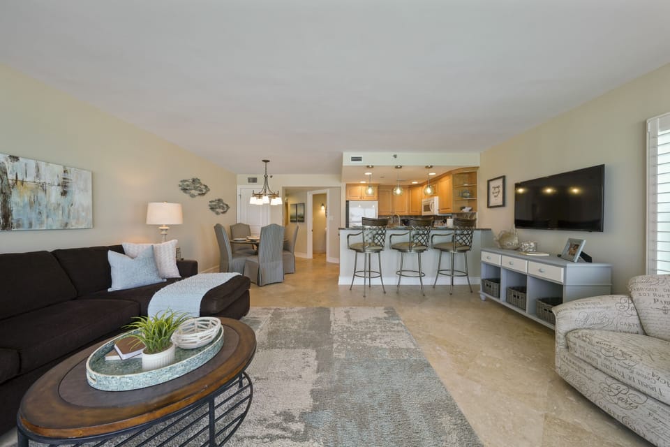 Enjoy spacious coastal living with a modern kitchen, breakfast bar seating, and comfortable furnishings in this Gulf front vacation rental.