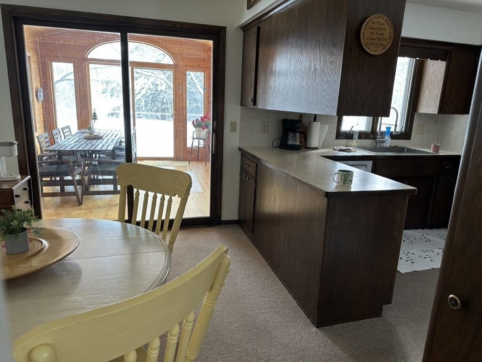 Looking into the kitchen and out on the sunroom. 