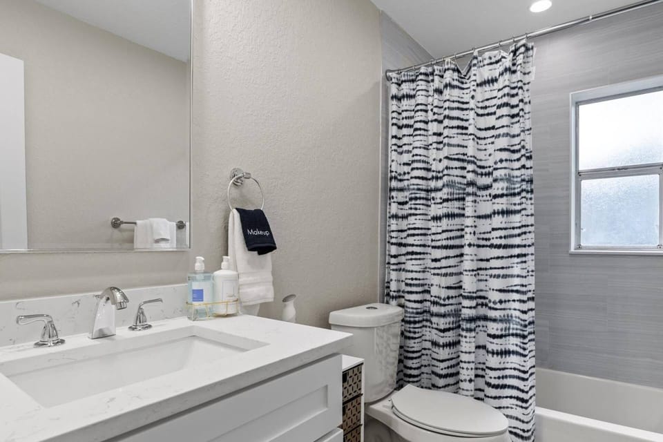 Shower/tub combo in the hall bath for use of guests in bedroom 2 and 3