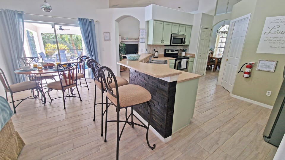 Kitchen with bar and stools