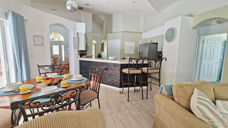 Dining room table near pool door and living room area 