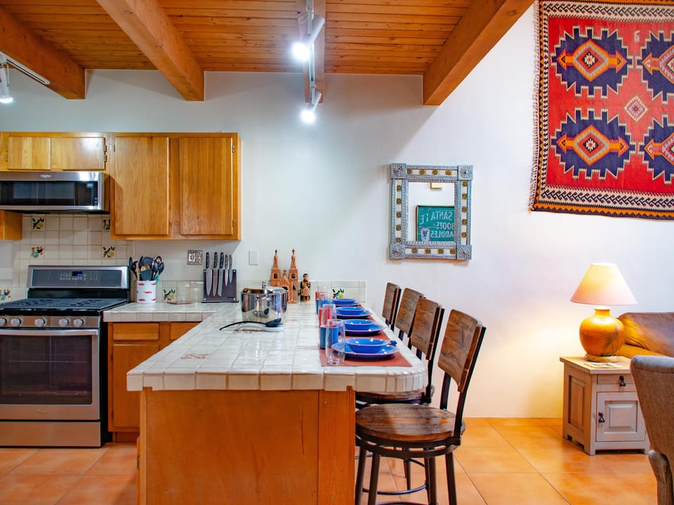 A kitchen with a table and chairs.