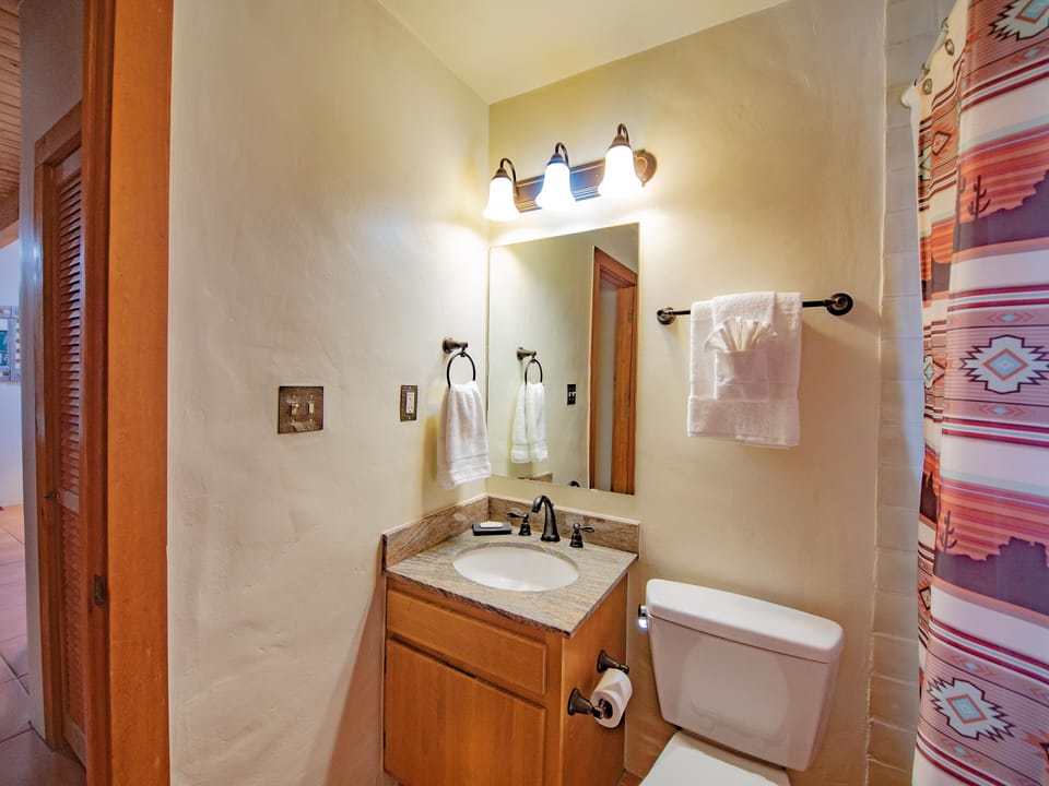 A bathroom with a toilet and sink.