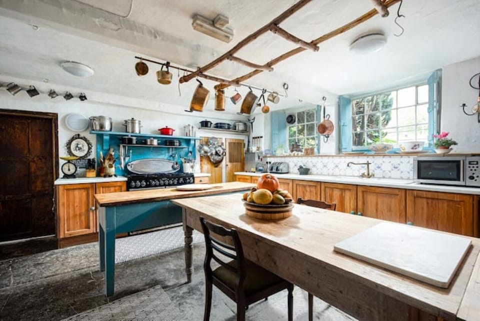 Country style kitchen with large prep tables and Range master stove
