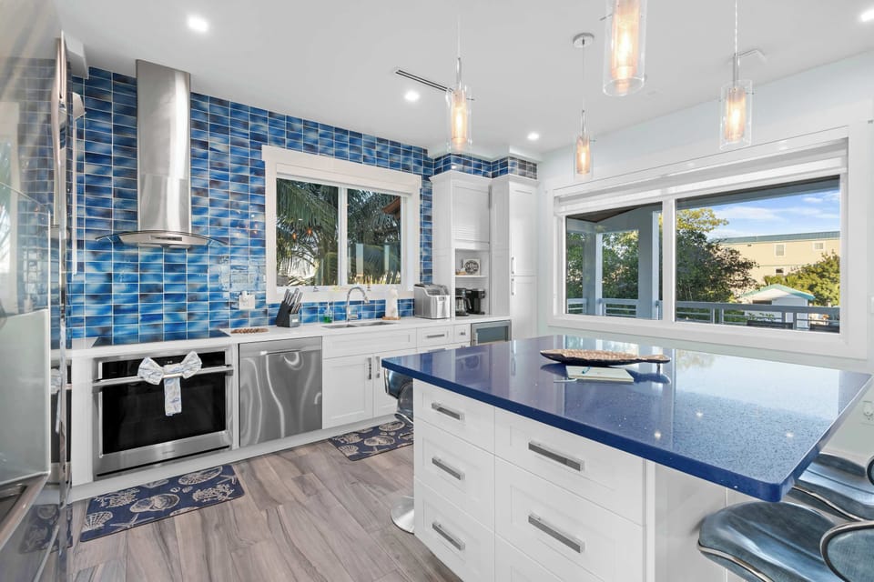 Step into this charming kitchen with its striking blue tile that adds a splash of personality! Whether you’re whipping up a gourmet meal or enjoying a comfy breakfast, this space is perfect for both chefs and casual cooks alike.