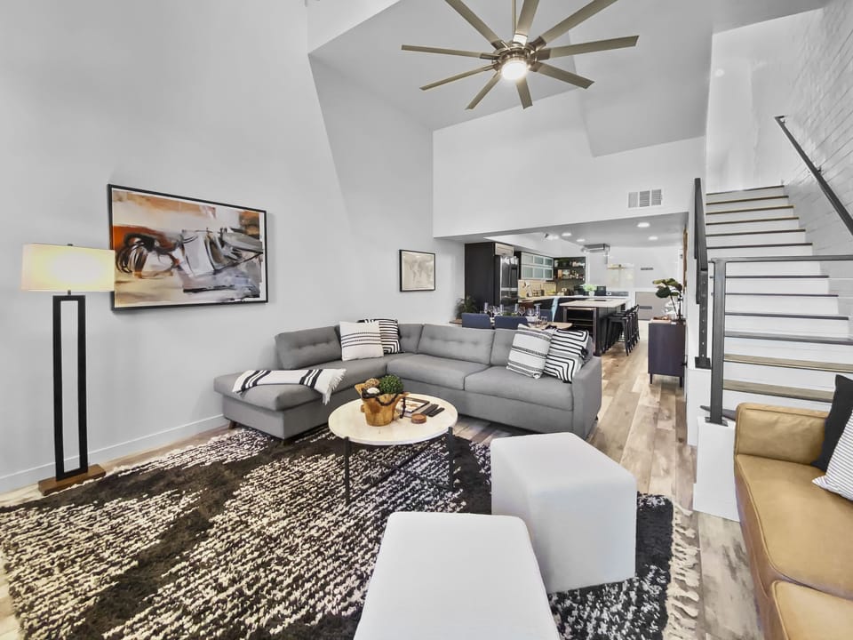 Relax in this cozy, modern living space. Features a warm fireplace, comfortable seating, and access to a patio. Perfect for unwinding.
