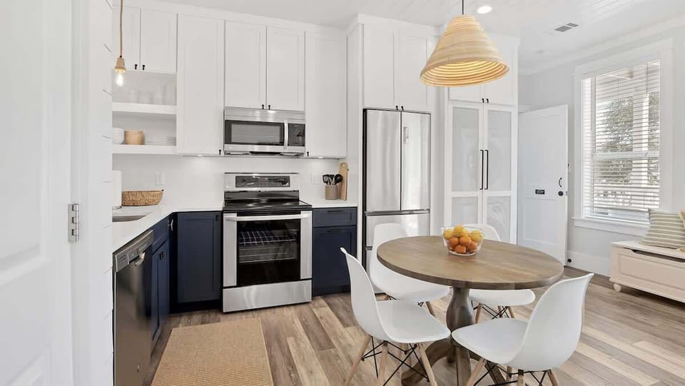 - Natural wood tones & coastal accents create a welcoming kitchen perfect for beachside living - Crisp white cabinetry & a modern pendant light define the stylish dining nook - Stainless steel appliances & open design make cooking easy & enjoyable