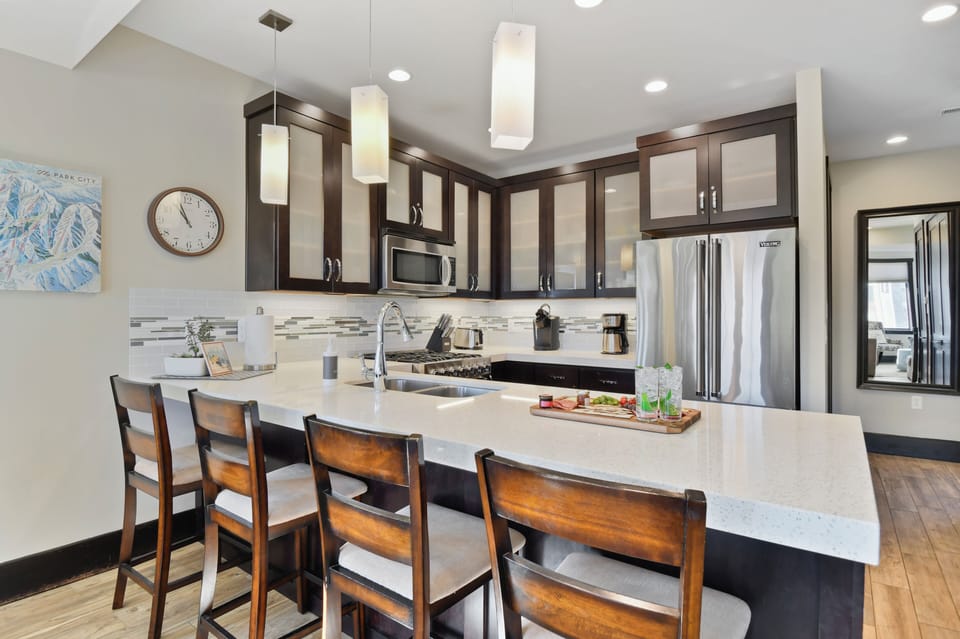 Featuring premium appliances, generous counter space, and bar seating, this fully equipped gourmet kitchen makes preparing everything from quick breakfasts to family dinners effortless.