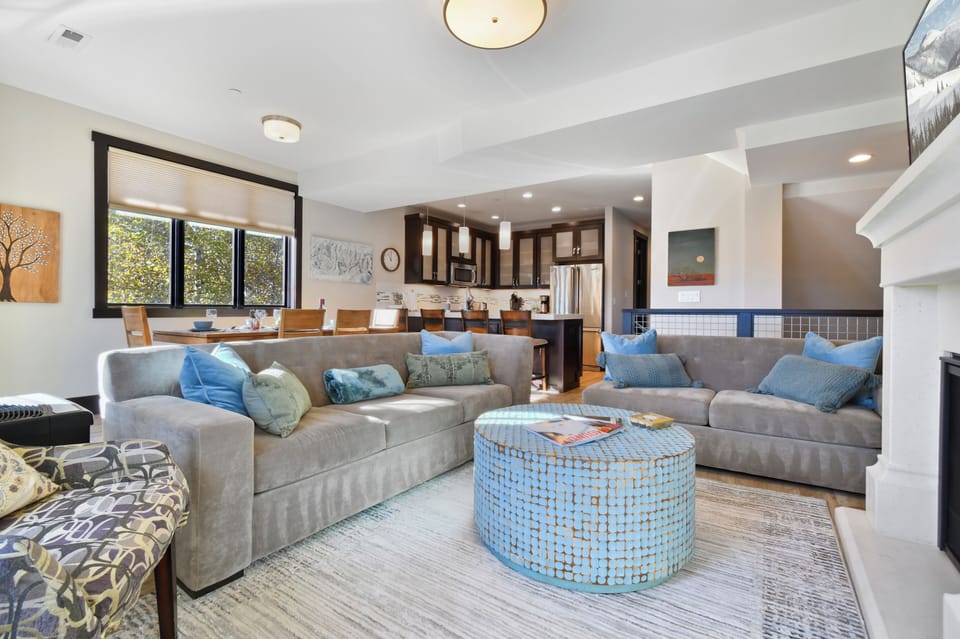 Enjoy a bright and welcoming open-concept layout that seamlessly connects the living room, dining area, and kitchen—perfect for relaxing, entertaining, and spending time together after a day exploring Park City.