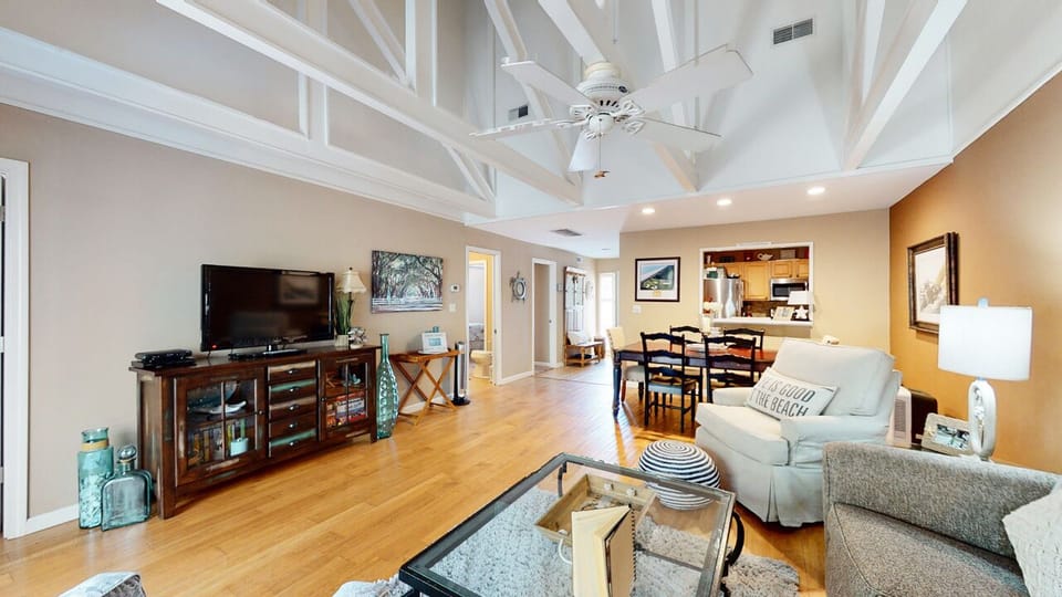 Thoughtfully furnished with plush seating, coastal accents, and a sliding glass door that opens to the deck.
