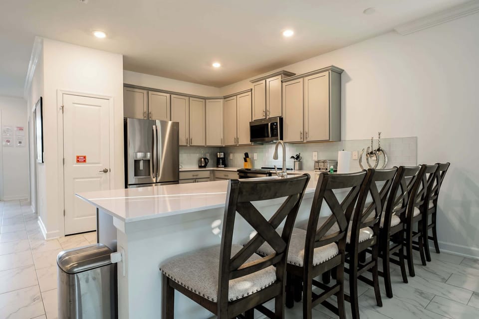 Spacious and modern kitchen with a large island, perfect for family gatherings and entertaining.