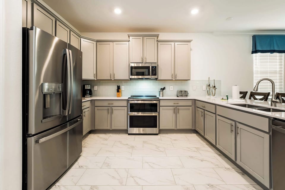 Spacious, modern kitchen with top-of-the-line appliances and elegant design, perfect for preparing family meals.